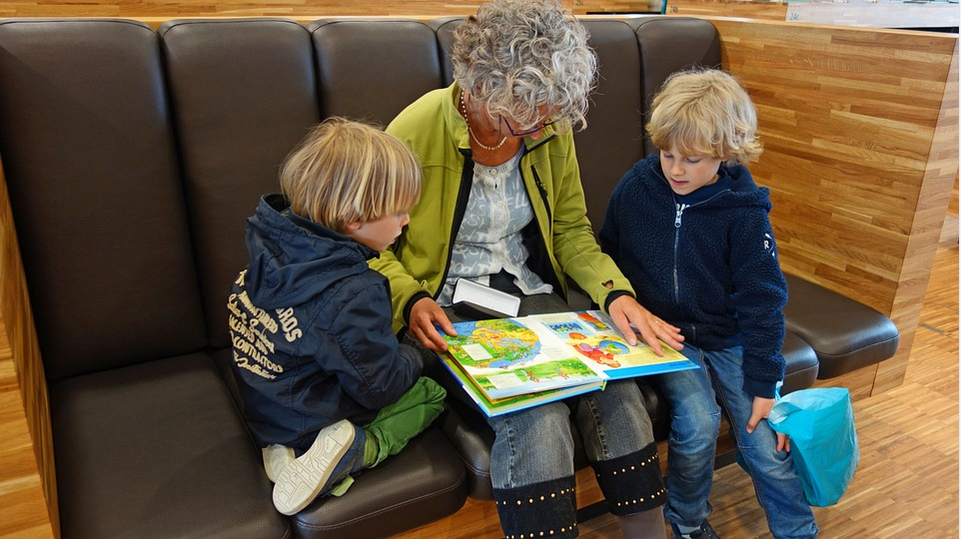 a granny and children reading